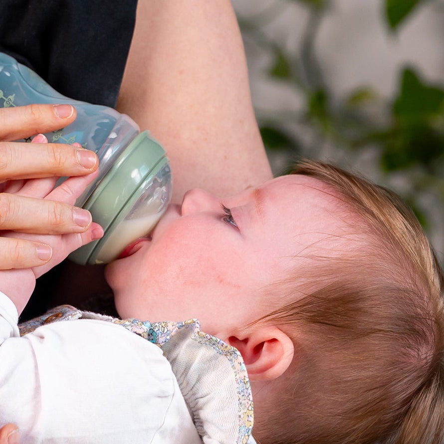 Woman feeding a baby with a bottle